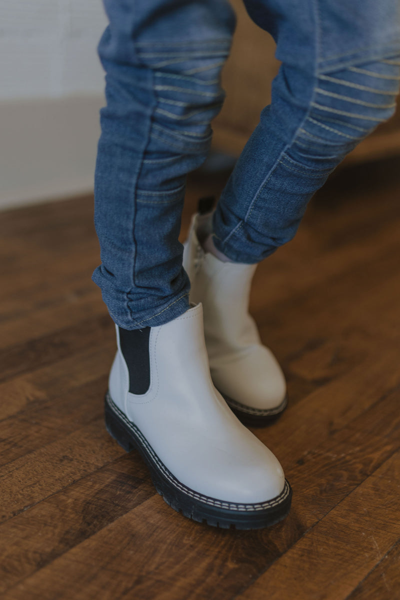 CAYLIE GIRLS WHITE BOOTIE WITH BLACK SOLE AND DETAILS